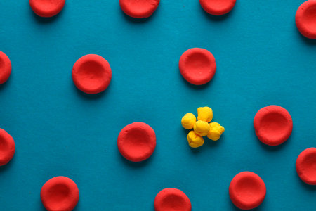 Red blood cells with lipids model made from plasticine on blue background. Cholesterolの写真素材