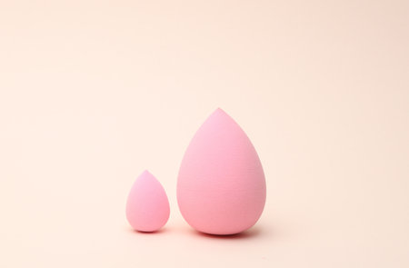 Make-up sponges, cosmetic blenders on beige background. Beauty products.の写真素材
