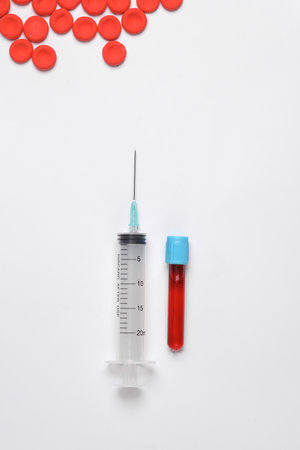 Test tube with blood and syringe, Red blood cells on white backgroundの写真素材