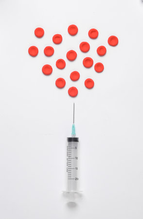 Syringe and Red blood cells on white backgroundの写真素材