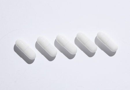 White pills on white background. Creative layoutの写真素材
