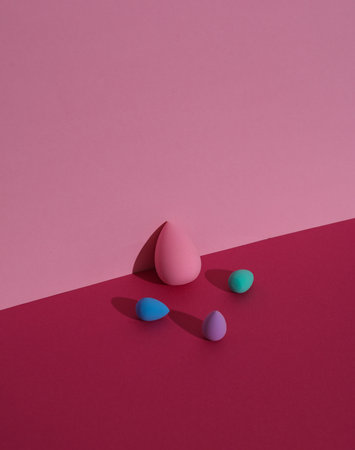 Makeup sponge blenders on a pink background with shadow. Beauty concept. Creative layout, minimalismの写真素材
