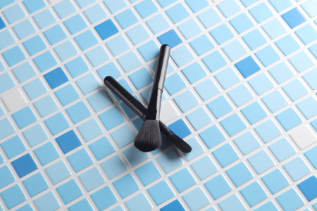 Makeup brushes on blue tiles. Beauty conceptの写真素材