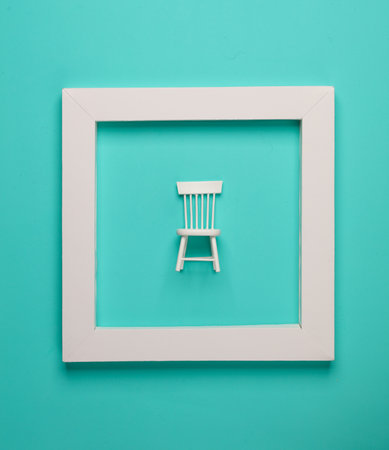 Chair in white frame on blue background. Creative layout. Minimalism