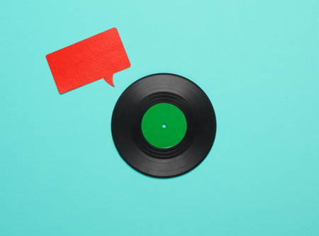 Vinyl record and speech bubble on blue background. Creative layout. Minimalismの写真素材