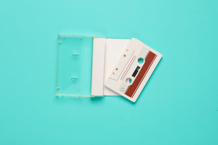Retro 80s audio cassette in box on blue background. Music concept, vintage technologyの写真素材