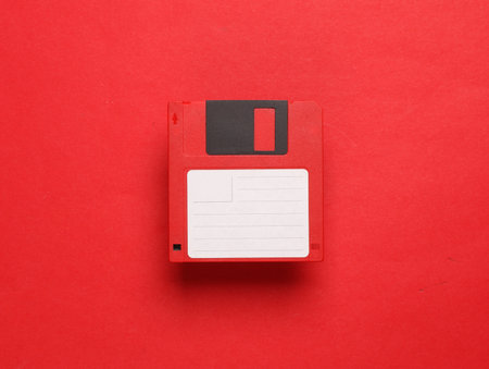 Red floppy disk on a red background. Retro 80s