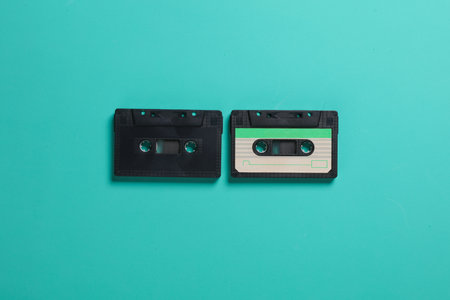 Many black audio cassettes on a blue background. Copy spaceの写真素材