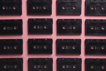 Background of many black audio cassettes. Top view
