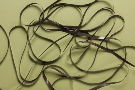 Rolled up magnetic tape on green backgroundの写真素材