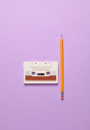 Audio cassettes with pencil on purple backgroundの写真素材