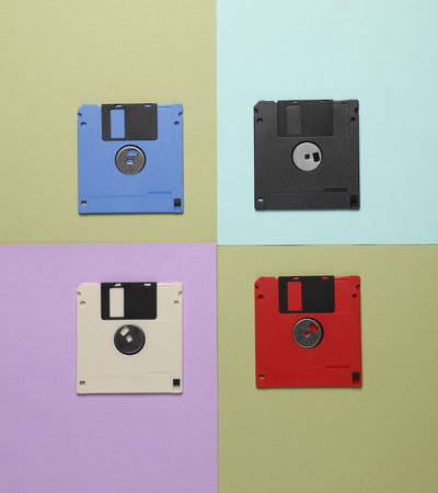Floppy disks on colored background. Creative layout, retro 80s, top view, conceptual popの写真素材