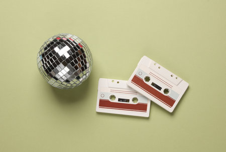 Disco ball with audio cassettes on a green background. Top viewの写真素材