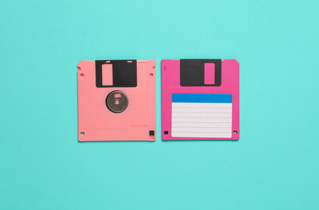 Two pink floppy disks on a blue background. Top viewの写真素材