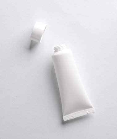 White Open cream tube on white background. Creative layout. Template for design. Mockup. Minimal beauty concept.の写真素材