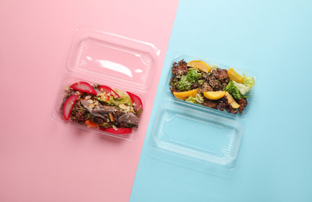 Salads in a plastic boxes on pink blue background. Tekaway food. Top view