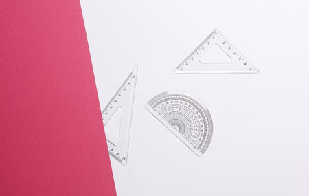 Set of rulers on white pink background. Back to school, geometry, exact sciences