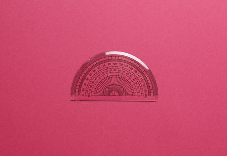 Ruler protractor on pink background