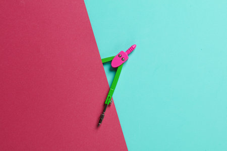Stationery Compasses in a blue-pink background. Top viewの写真素材