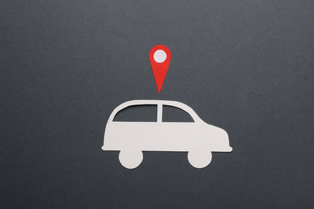 Paper cut car icon with gps navigation point on gray backgroundの写真素材
