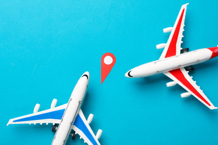 Geolocation point (location pin) and air planes on blue background. Travel concept