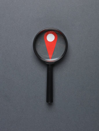 Maps Marker icon, geolocation point with magnifying glass on dark gray background