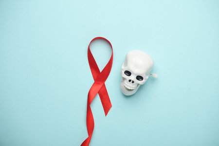 Red AIDS Awareness Ribbon and skeleton on blue Background