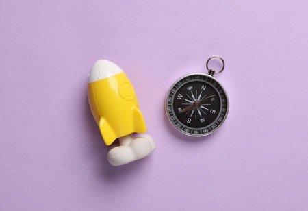 Space shuttle with a compass on a magenta background. Business conceptの写真素材