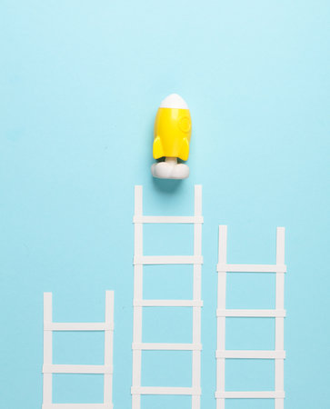 White paper stairs with rocket on blue background. Business concept, startup