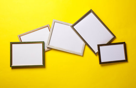 Blank wall frames on yellow backgroundの写真素材