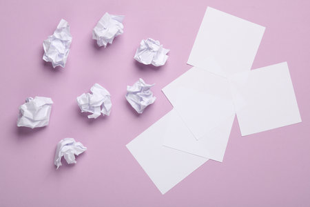 Crumpled paper balls with memo papers on a pastel background. Business concept