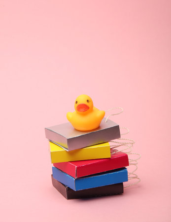 Paper Miniature shopping bags with rubber duck on a pink background. Black Friday, world shopping day, saleの写真素材