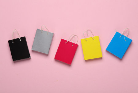 Miniature shopping bags on a pink background. Black Friday, world shopping day, sale