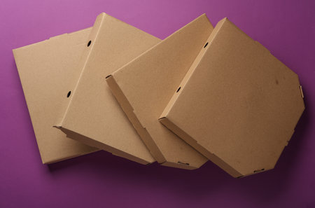 Cardboard craft pizza boxes on a purple background. Top viewの写真素材