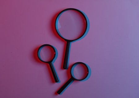 Magnifiers in blue pink neon lightの写真素材