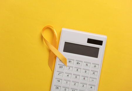Yellow ribbon with calculator, childhood cancer awareness day symbolの写真素材