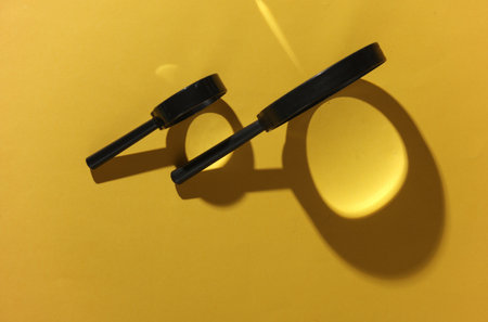 Magnifier with shadow on yellow background