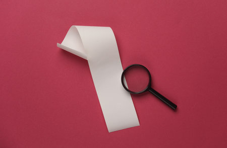 Blank Cash Receipt Sales Check and Magnifying glass on pink backgroundの写真素材