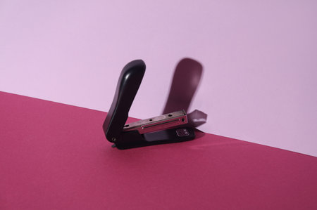Stapler on pink background. Creative layoutの写真素材