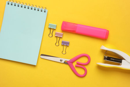 Set of school stationery on a yellow background. Fat lay. Top view