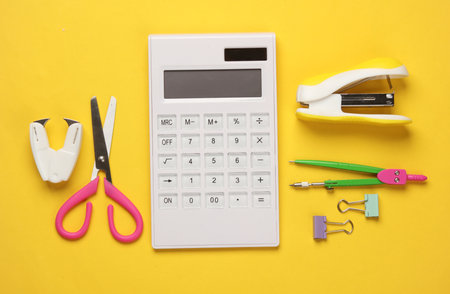 School and office supplies on yellow background. Flat lay, top view.