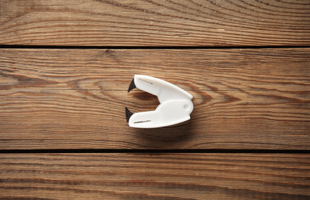 Anti-stapler on wooden table. Top viewの写真素材