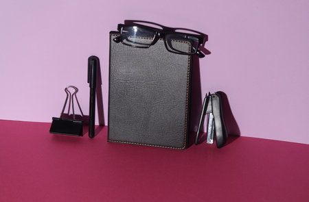 Black Office stationery on pink background. Creative layout