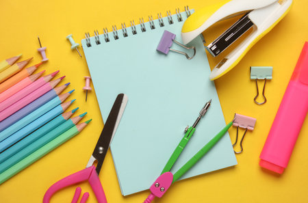 Set of school stationery on a yellow background. Fat lay. Top view
