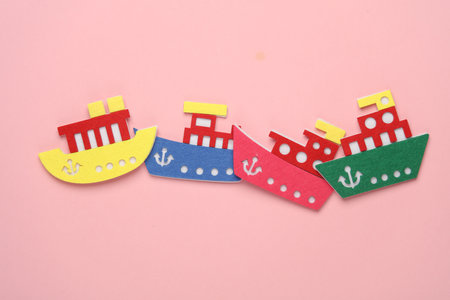Toy made ships of felt on pink background. Travel conceptの写真素材