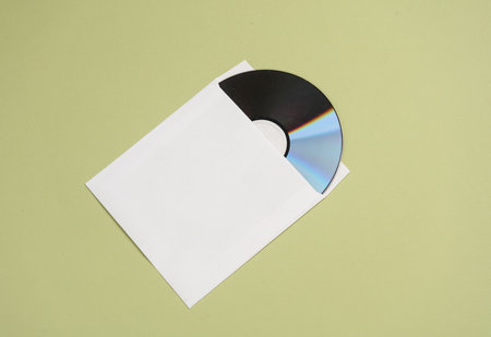 Mockup of CD disc in Paper pack on green backgroundの写真素材