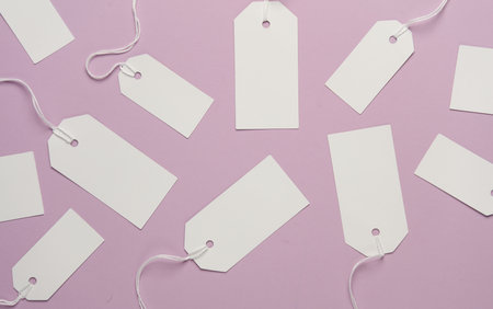 Set of blank white tags with ropes on magenta background. Mock up, Template for design. Sale,...