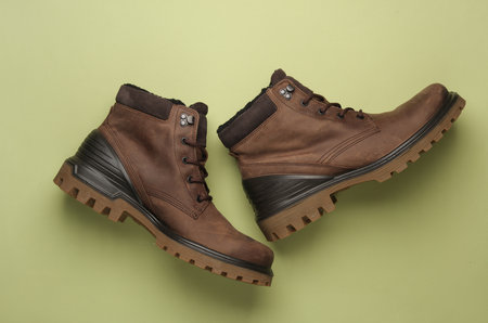 Leather boots on a green background. Top view