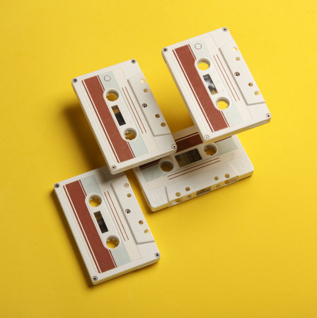 Floating retro 80s audio cassettes on a yellow background. Conceptual pop, creative layout. Minimalismの写真素材