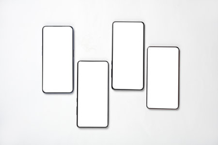 Four smartphones on a white background